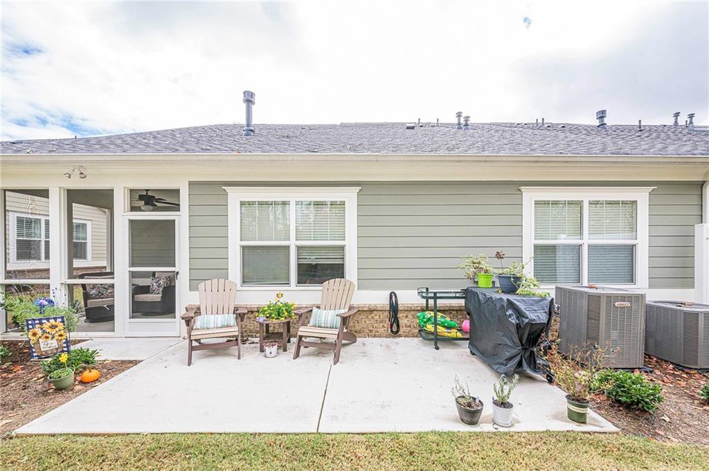 701 Calypso Way Cumming, GA 30040 - Photo 42 of 54 a view of a house with chairs and table in a patio