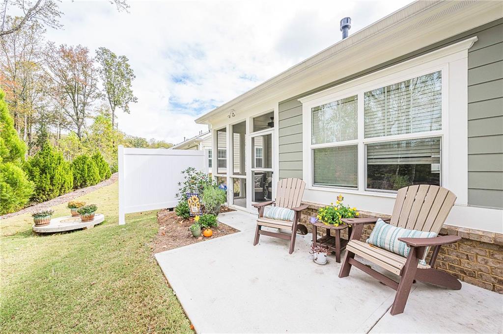 701 Calypso Way Cumming, GA 30040 - Photo 43 of 54 a view of a patio with table and chairs and potted plants