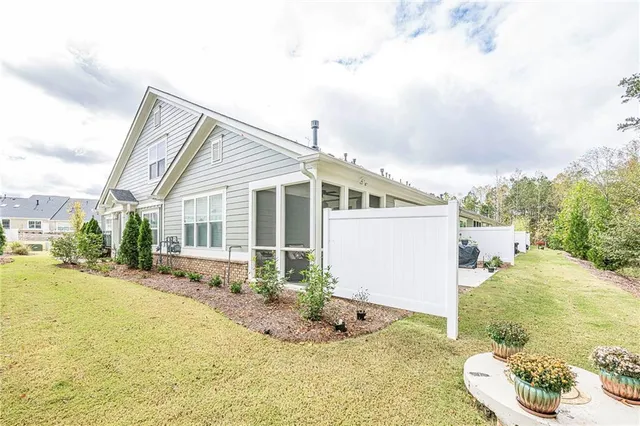 a kitchen with kitchen island a refrigerator a stove a sink a dining table and chairs