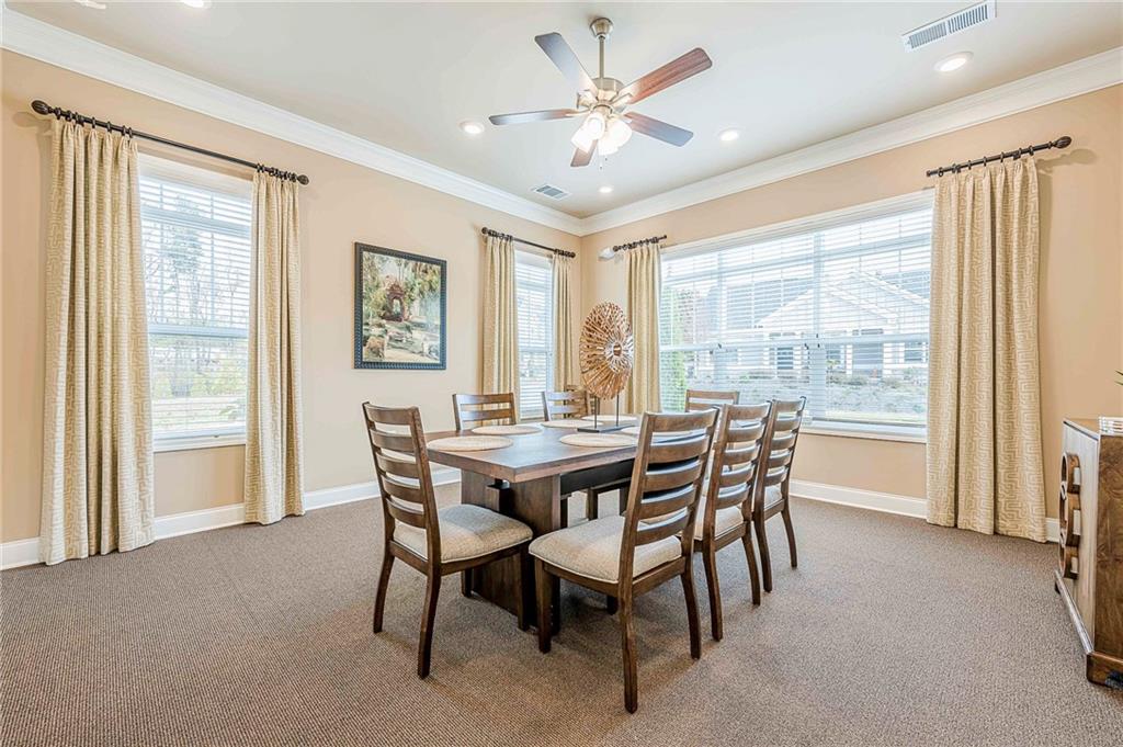 701 Calypso Way Cumming, GA 30040 - Photo 50 of 54 a dining room with furniture a rug and a large window