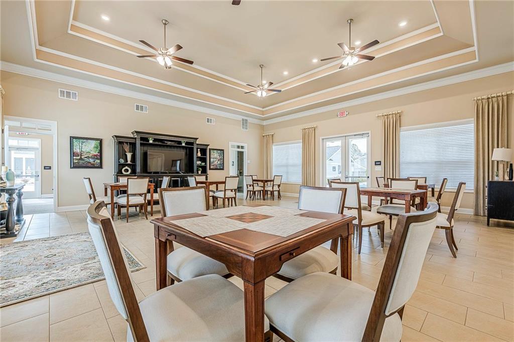 701 Calypso Way Cumming, GA 30040 - Photo 51 of 54 a view of a dining room with furniture a chandelier and wooden floor