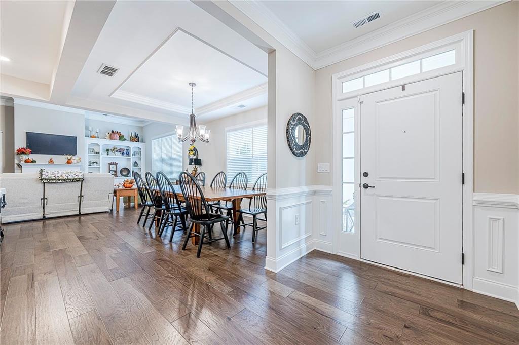 701 Calypso Way Cumming, GA 30040 - Photo 6 of 54 a view of a dining area with furniture and wooden floor