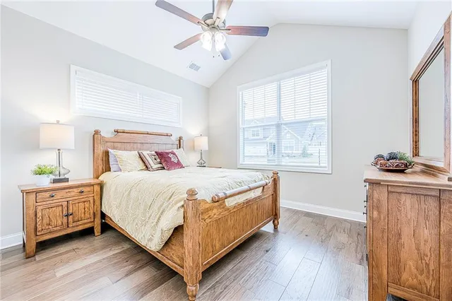 a bedroom with a bed and a night stand