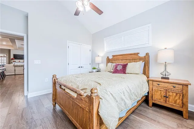 a bedroom with a large bed and a chandelier