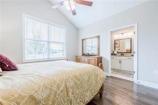 a bathroom with a granite countertop sink mirror toilet and shower