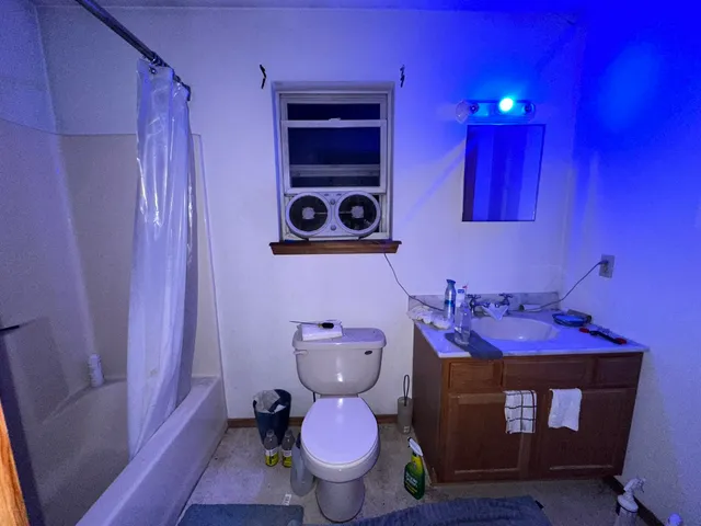a bathroom with a toilet sink and mirror