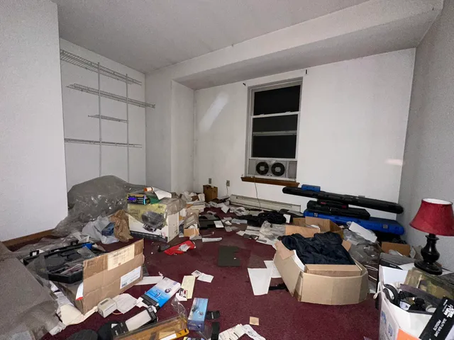 a room with furniture a rug and white walls