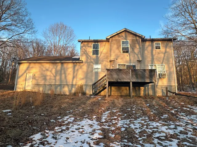 a view of a chairs and table in the backyard of the house