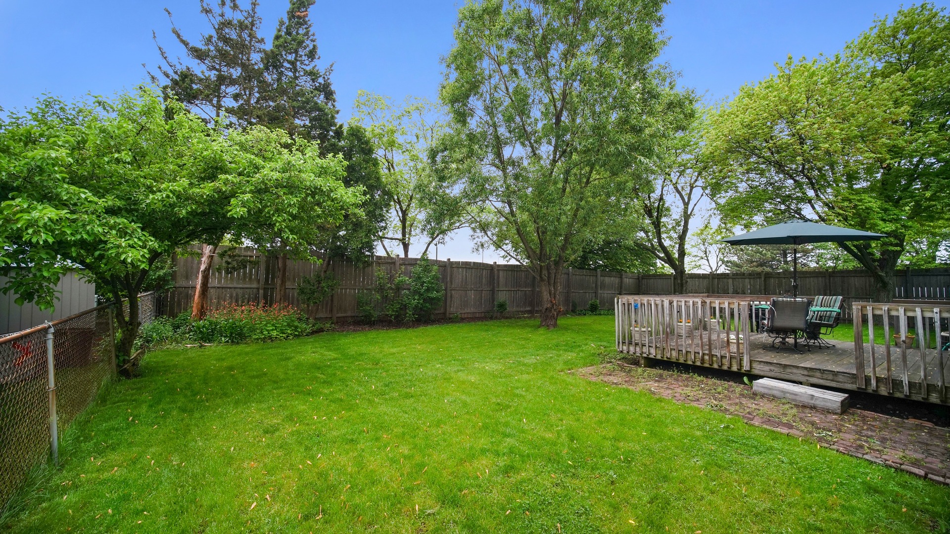 30 Timber Hill Road Buffalo Grove, IL 60089 - Photo 23 of 23 a view of backyard with wooden fence and a large tree