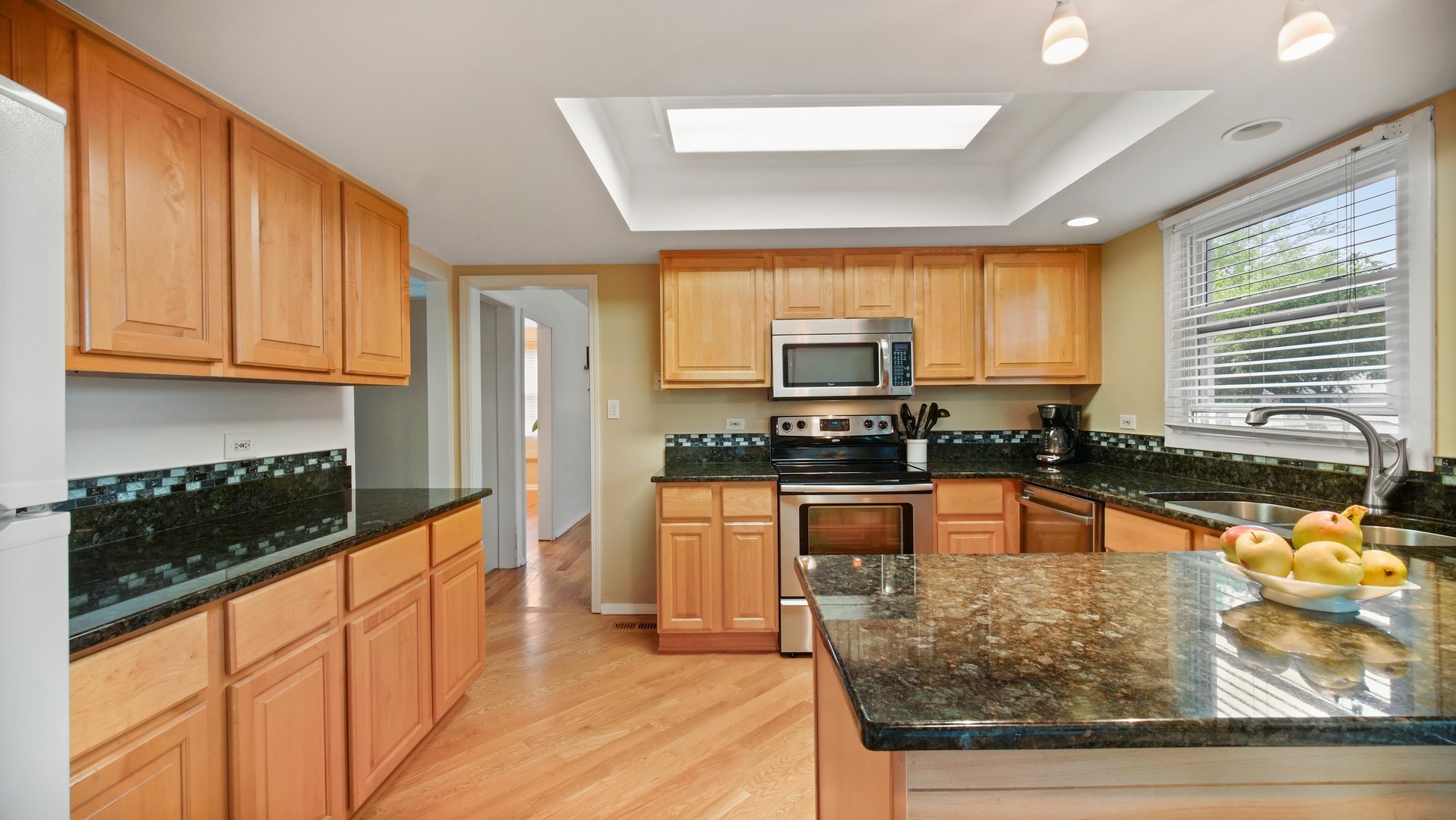 30 Timber Hill Road Buffalo Grove, IL 60089 - Photo 7 of 23 a kitchen with stainless steel appliances granite countertop a stove a sink and a microwave
