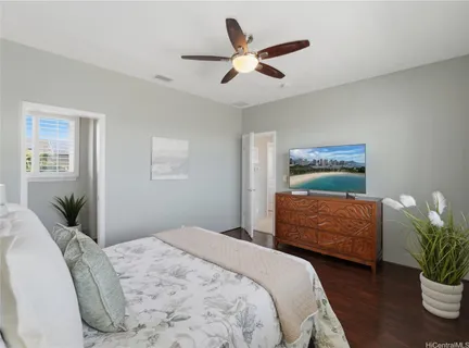 a bedroom with a large bed chandelier and a window