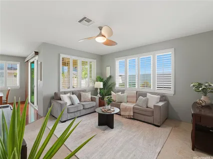 a living room with patio furniture and a large window