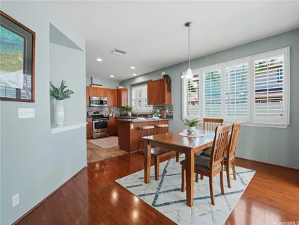a dining room with furniture a window and wooden floor
