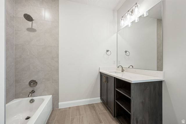 684 West High Tide Place, Unit 131 St. George, UT 84790 - Photo 15 of 27 Bathroom featuring a single vanity with a white countertop, dark wood-finish cabinetry, and an integrated rectangular sink