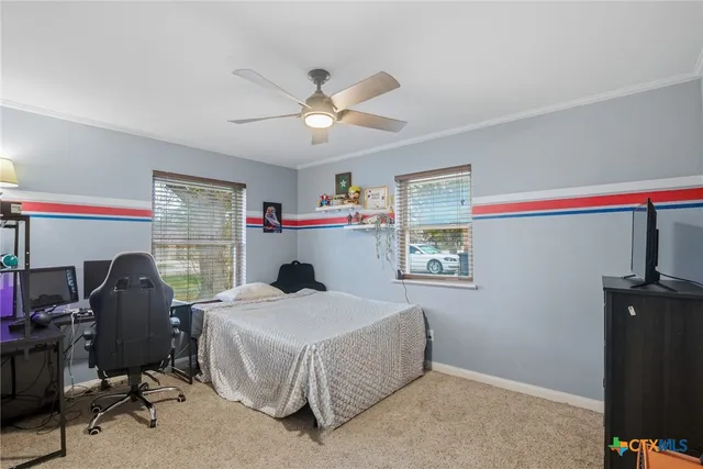 a bedroom that has a bed and a desk in it