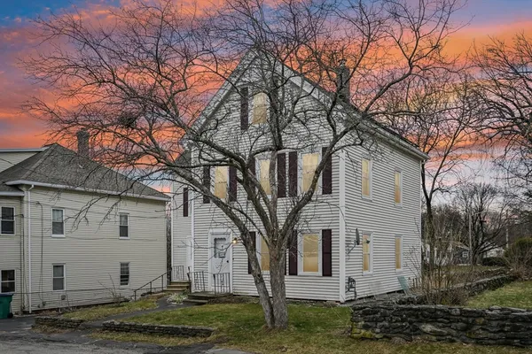 a view of a white house with a yard