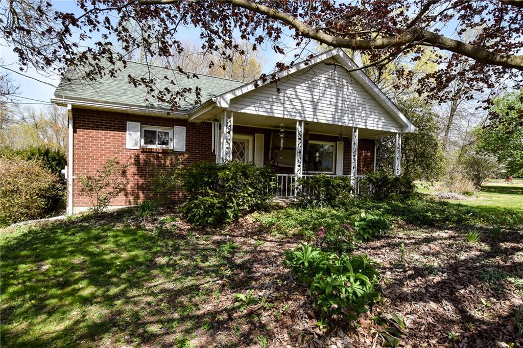 front view of a house with a tree