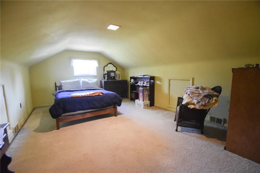 109 Neupert Road Cabot, PA 16023 - Photo 12 of 17 a bedroom with a bed and a chandelier