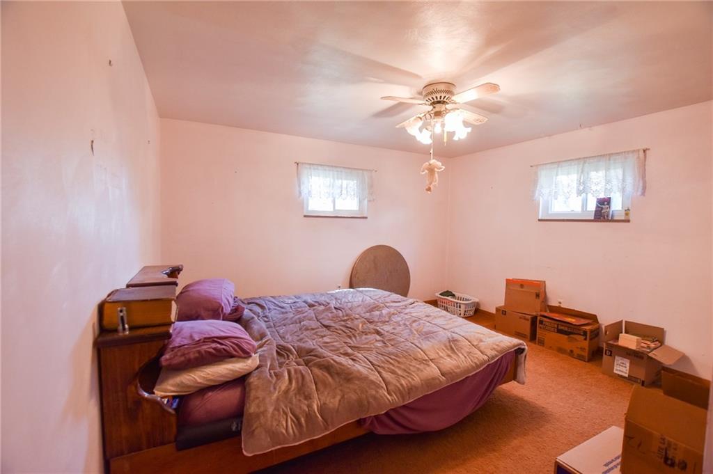109 Neupert Road Cabot, PA 16023 - Photo 9 of 17 a bedroom with a bed and a chandelier