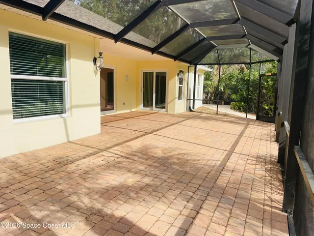 a view of empty room with wooden floor and outdoor view