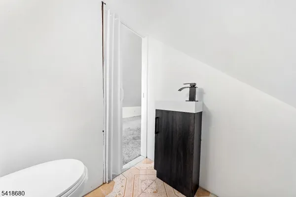 a white toilet sitting next to a bathroom sink