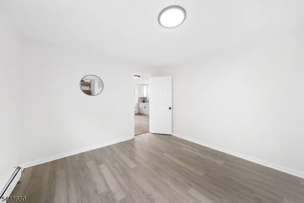 a view of a room with wooden floor