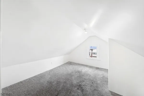 a view of a room with wooden floor and a window