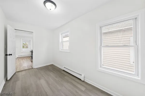 a view of a kitchen with a sink a refrigerator and window