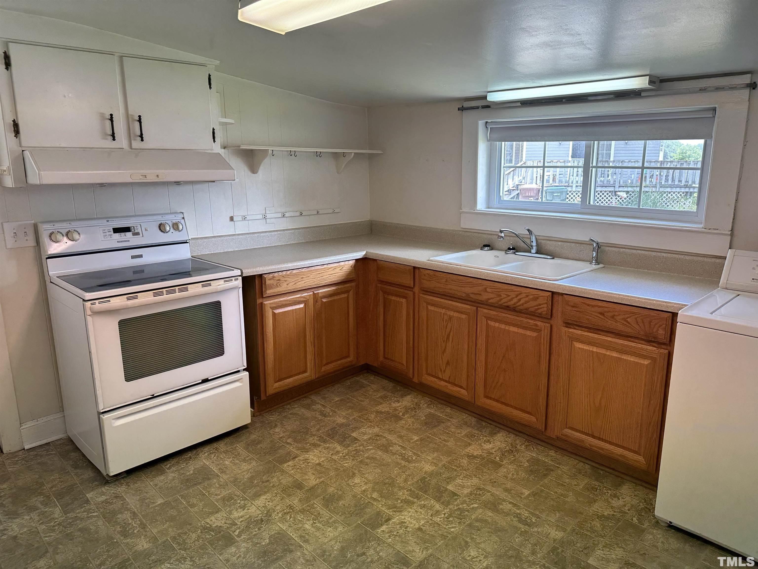 265 Iris Bryant Road Erwin, NC 28339 - Photo 2 of 11 a kitchen with a stove and white cabinets