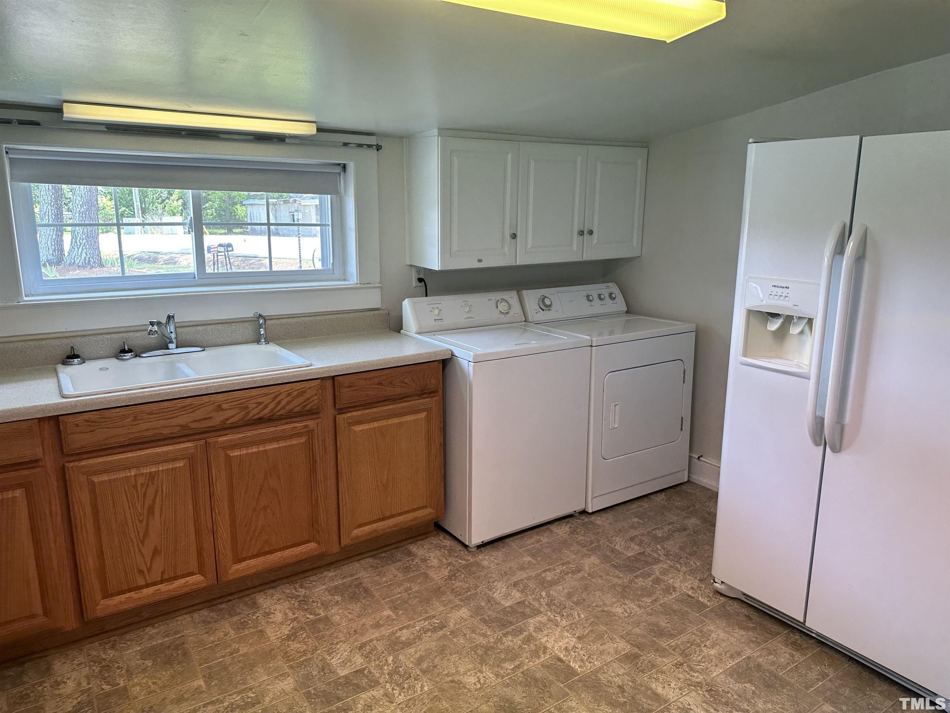 265 Iris Bryant Road Erwin, NC 28339 - Photo 4 of 11 a utility room with cabinets washer and dryer
