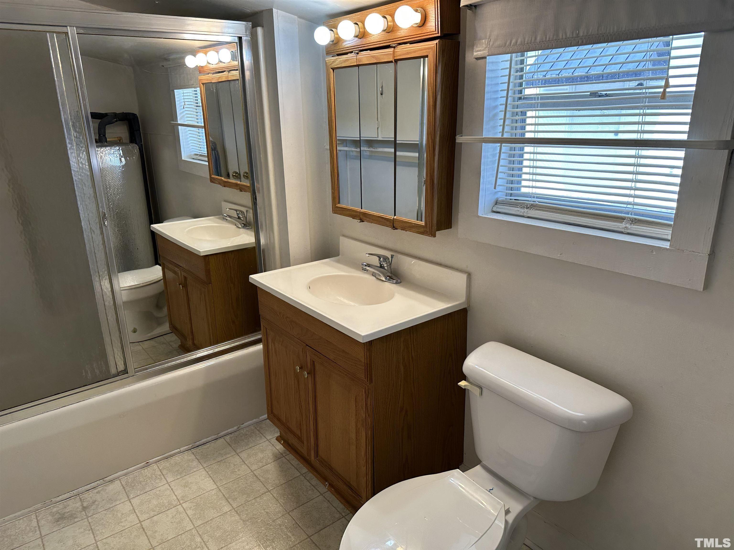265 Iris Bryant Road Erwin, NC 28339 - Photo 6 of 11 a bathroom with a toilet sink and mirror