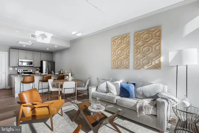 a living room with furniture and kitchen view