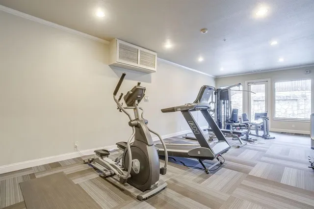 a patio with table and chairs and potted plants
