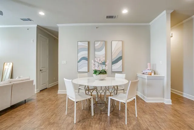 a view of a dining room with furniture a chandelier and wooden floor