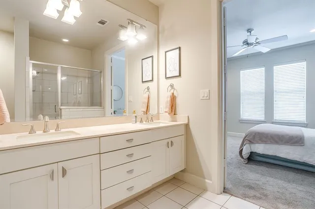 a spacious bathroom with a double vanity sink mirror and double