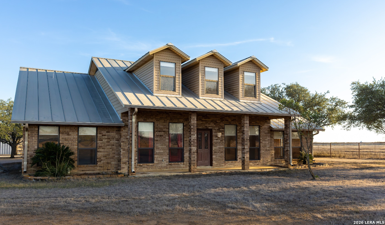 375 Bluntzer Road Jourdanton, TX 78026 - Photo 18 of 44 a front view of a house with a porch
