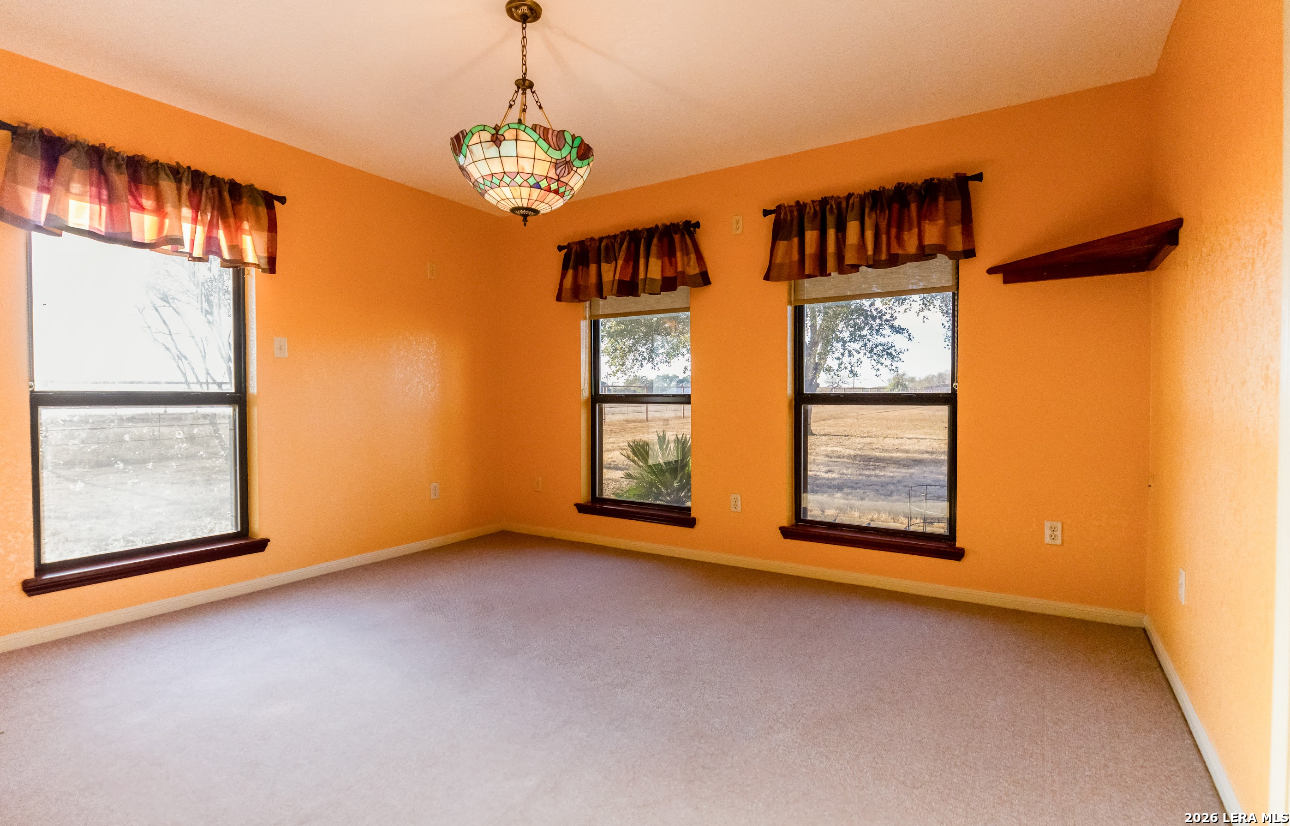 375 Bluntzer Road Jourdanton, TX 78026 - Photo 24 of 44 an empty room with windows and entryway