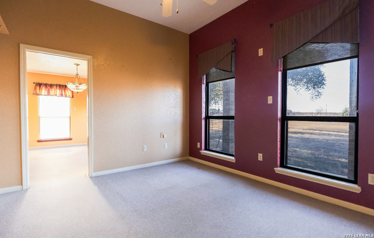 375 Bluntzer Road Jourdanton, TX 78026 - Photo 26 of 44 an empty room with windows and closet