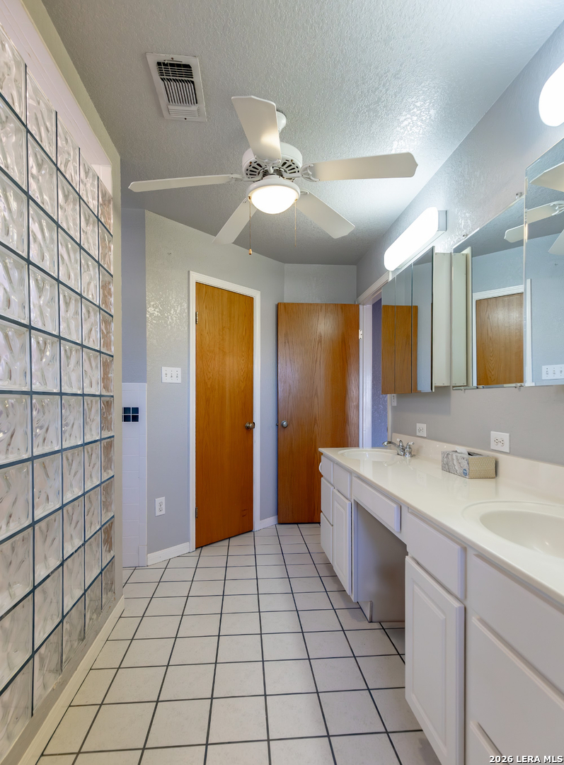 375 Bluntzer Road Jourdanton, TX 78026 - Photo 33 of 44 a spacious bathroom with a mirror and a shower