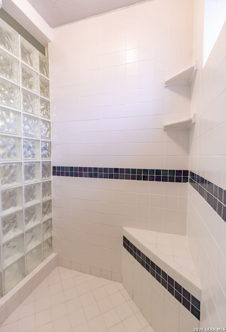 375 Bluntzer Road Jourdanton, TX 78026 - Photo 34 of 44 a bathroom with a bathtub and shower