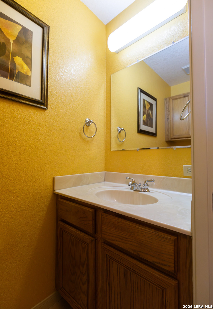 375 Bluntzer Road Jourdanton, TX 78026 - Photo 40 of 44 a bathroom with a sink and a mirror