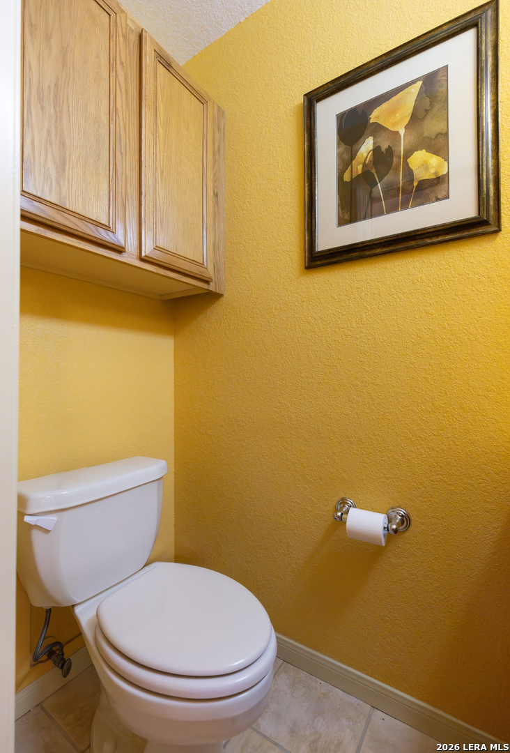 375 Bluntzer Road Jourdanton, TX 78026 - Photo 41 of 44 a white toilet sitting next to a blue wall
