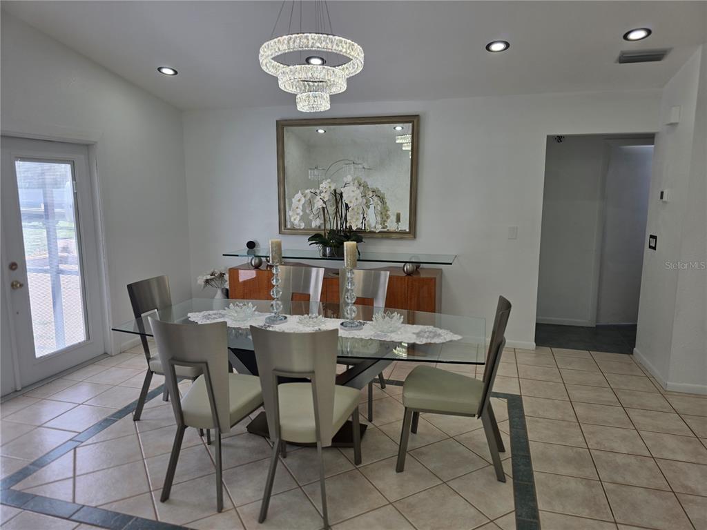 13128 Hazelcrest Street Spring Hill, FL 34609 - Photo 16 of 46 a view of a dining room with furniture