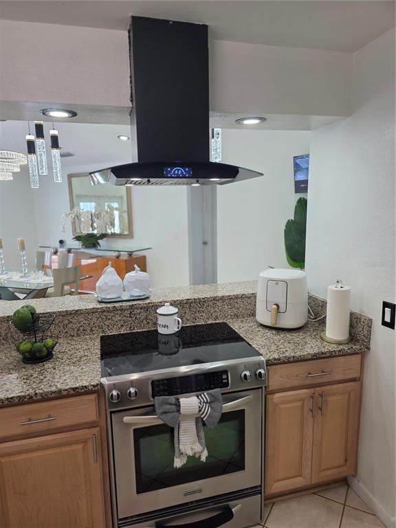 13128 Hazelcrest Street Spring Hill, FL 34609 - Photo 17 of 46 a stove top oven sitting inside of a kitchen