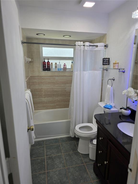 13128 Hazelcrest Street Spring Hill, FL 34609 - Photo 19 of 46 a bathroom with a sink a toilet and shower