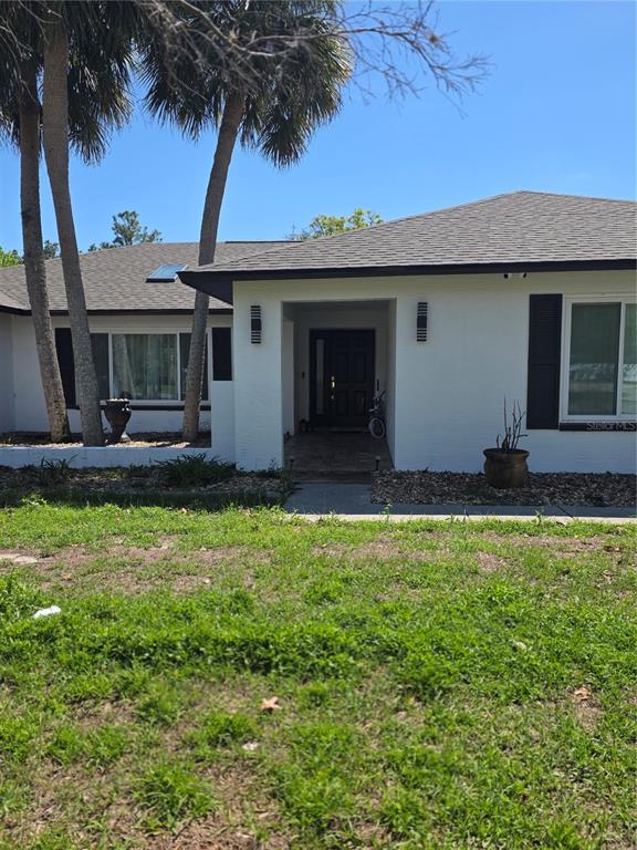 13128 Hazelcrest Street Spring Hill, FL 34609 - Photo 2 of 46 a house view with a garden space