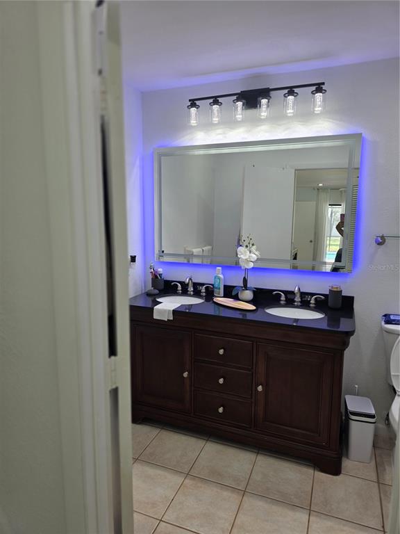 13128 Hazelcrest Street Spring Hill, FL 34609 - Photo 21 of 46 a bathroom with a sink vanity and mirror