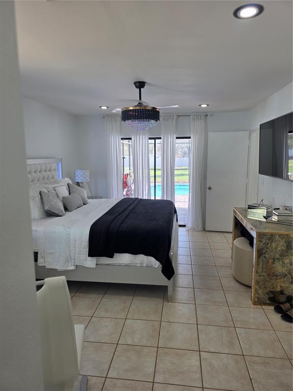 13128 Hazelcrest Street Spring Hill, FL 34609 - Photo 23 of 46 a bedroom with a bed and a television