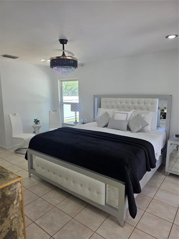 13128 Hazelcrest Street Spring Hill, FL 34609 - Photo 24 of 46 a bedroom with a bed and window