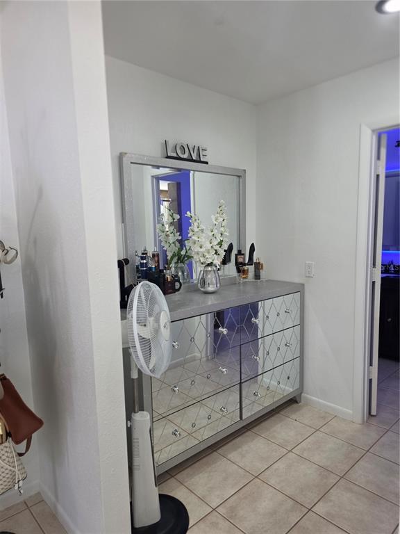 13128 Hazelcrest Street Spring Hill, FL 34609 - Photo 25 of 46 a room with round mirror and cabinets